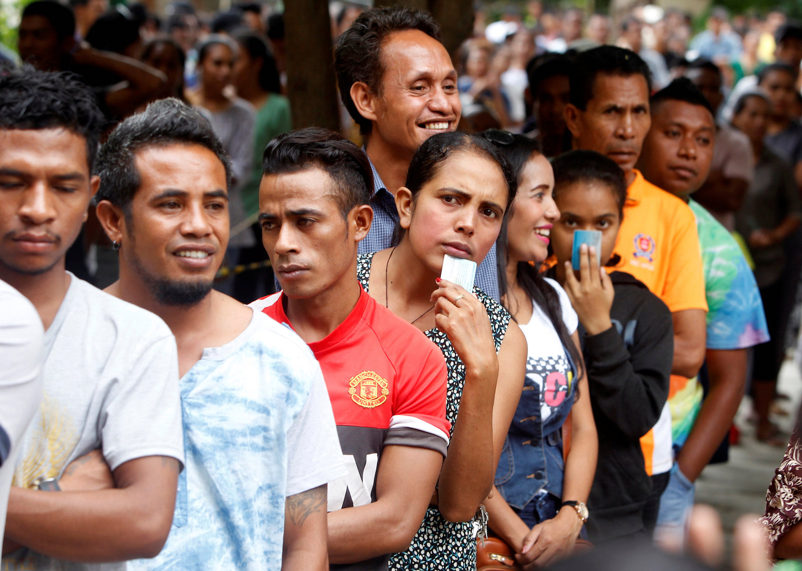 East Timorese ling up to cast their vote in a general election at a polling station in Dili